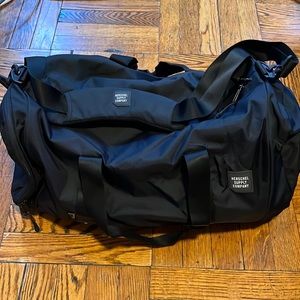 Herschel Supply Company black duffel bag.